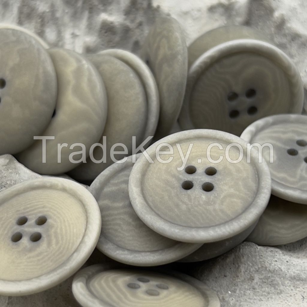 Soft colored corozo buttons in mild grey, yellow and brown
