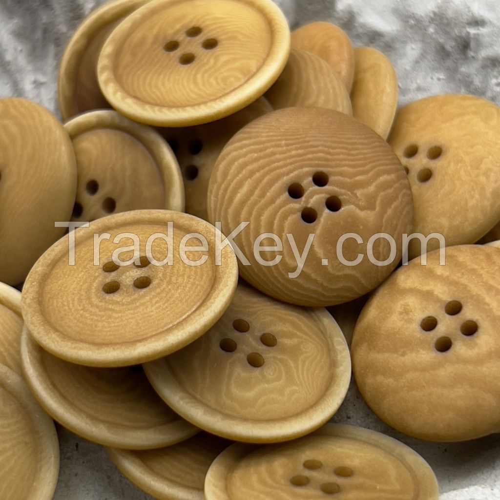 Soft colored corozo buttons in mild grey, yellow and brown
